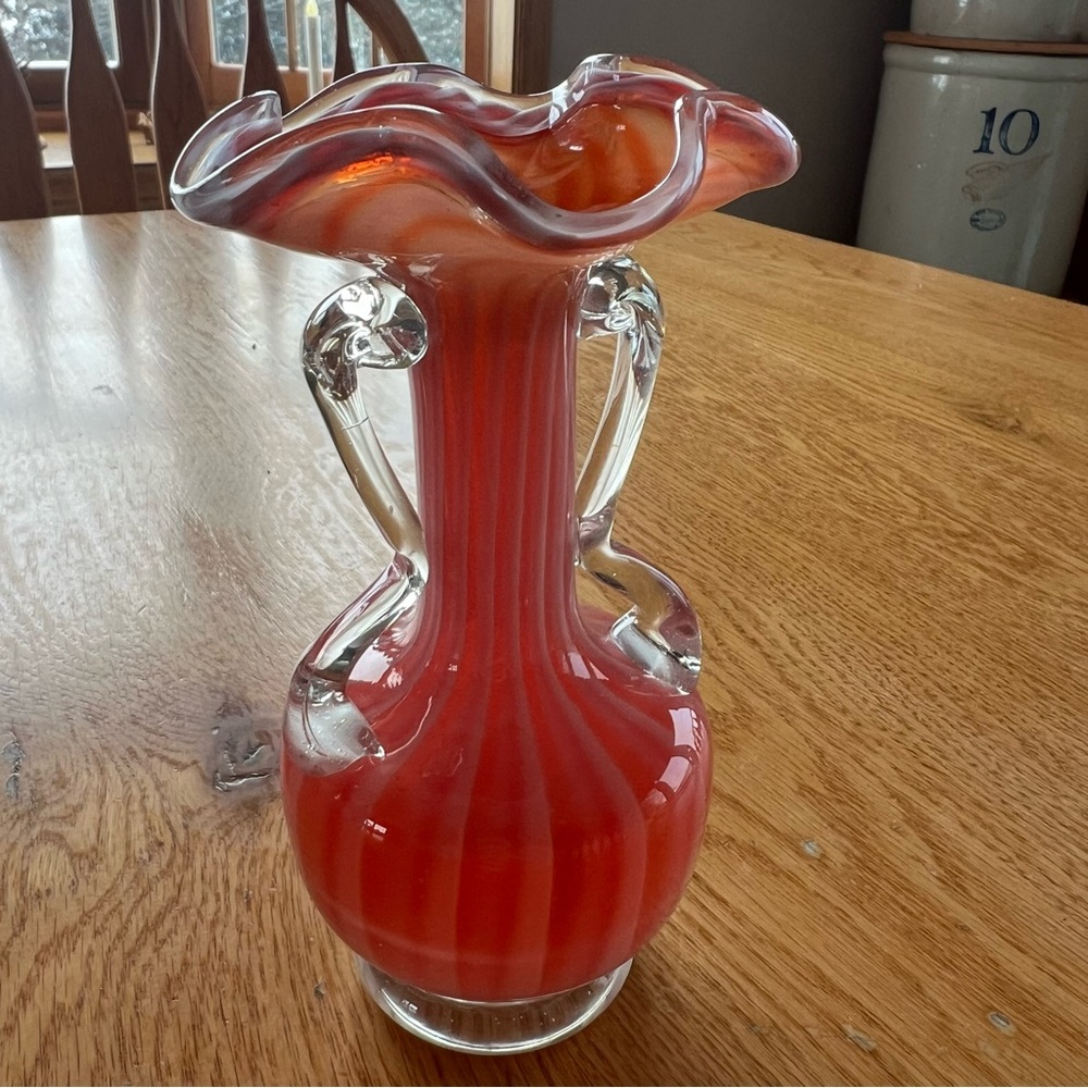 Victorian art glass vase with red and white swirl and ruffled rim.